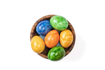 Different easter eggs in ceramic bowl isolated on white