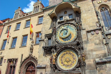 Ancient medieval Prague Astronomical Clock (Pražský orloj) and calendar plate in the wall of the Old Town Hall. Sunny day with blue sky.