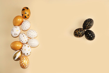 Decorated golden easter eggs on a yellow background. Minimal holiday concept. Happy easter...