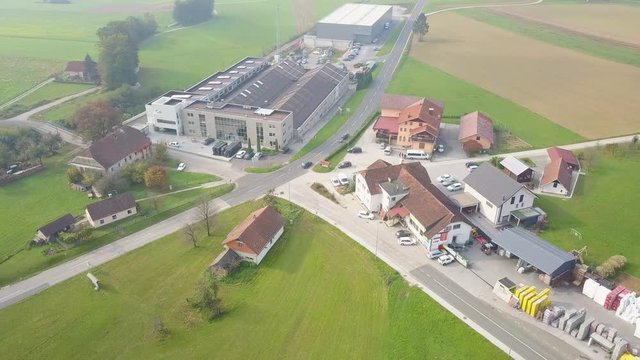 A beautiful infrastructure with transportation, houses and green fields in the rural area. Aerial view.