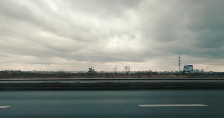 driving on highway on cloudy day.