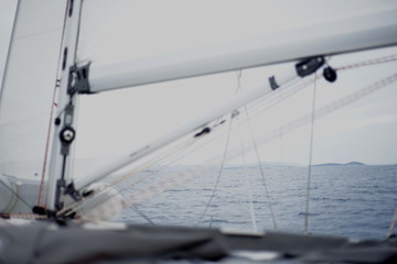 Detail of a moving sailboat with main mast and rigging