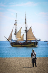 Brig next to the coast. Napoleonic soldier on a beach. Historical reenactment of a British landing....