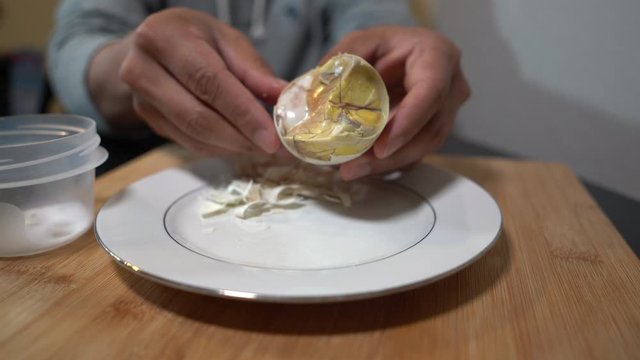 Taking out balut shell before eating