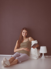Woman sitting on the floor using a digital tablet