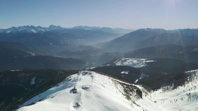 Aerial view of the pistes and lifts in the Gitschberg Jochtal skiing region, South Tyrol. Dolly shot with beautiful mountains in the background.