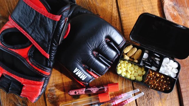mma gloves with steroids composition on wooden background