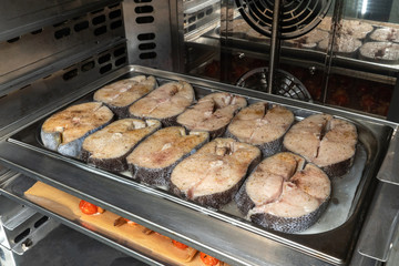 Cooking fish in the oven, restaurant. Cooking for catering.
