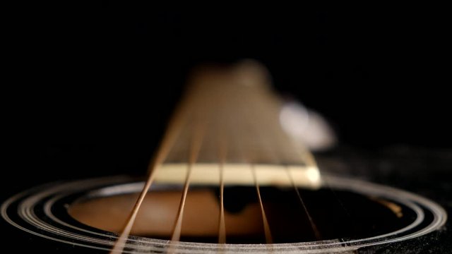 Unique perspective of guitar strings and fretboard of an acoustic guitar