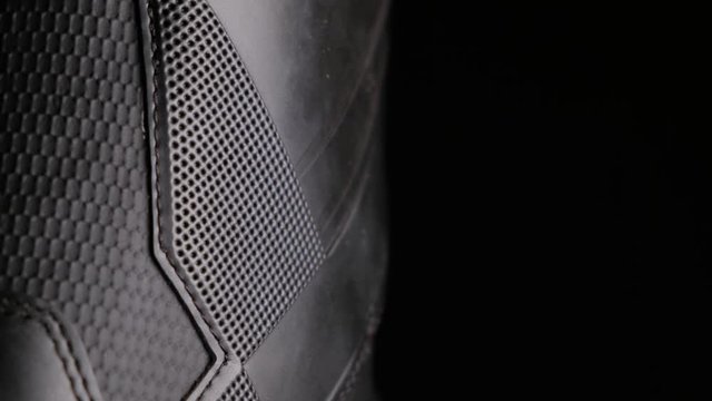 A close up shot of snowboard boots against black background, abstract pattern, black & white design, with black empty negative space, room for text and title, vivid light fall off and highly detailed