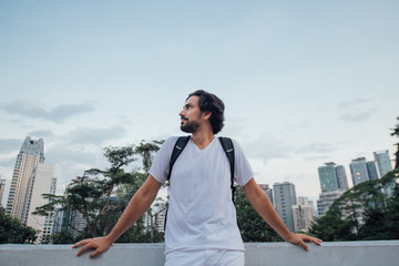 A man admires the view against the backdrop of skyscrapers