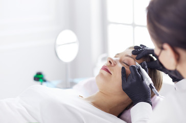 Microblading eyebrows work flow in a beauty salon.