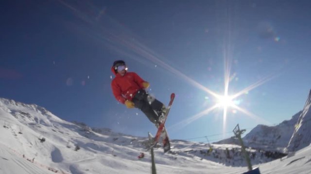 Male skiier jumps in a snowpark.