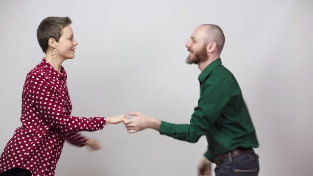Swing dancers on white background. Man and woman are dancing lindy hop or boogie woogie dance. Happy couple dancing.
