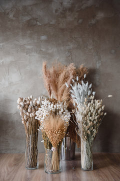 Dried Flowers In A Vase Against A Gray Wall
