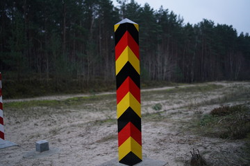 Close up of black red gold colored pole at the german border