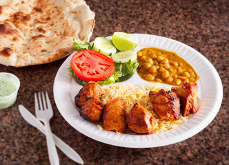 Chicken Kabob entree with rice, chickpeas, salad and naan bread