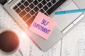 Writing note showing Self Employment. Business concept for working for oneself as a freelance or the owner of a busines Trendy metallic laptop sticky pad pen coffee cup lying vintage table
