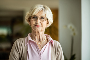 Portrait of smiling mature woman at home.