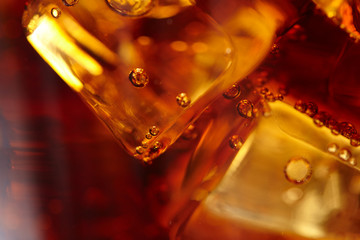 cola with ice cubes, macro