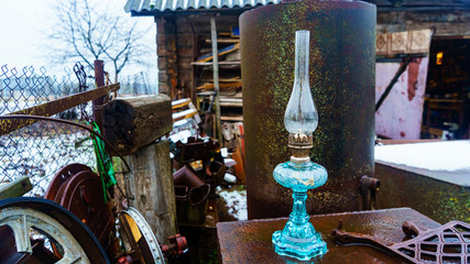 Fototapeta na wymiar Close-up old blue kerosene lamp on the rustic background.