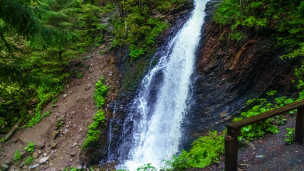 Fototapeta na wymiar Guk Falls breaks through rocks in Carpathians mountains. Travel concept.