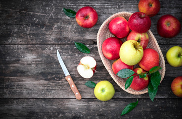 .apples in a basket on a wooden background