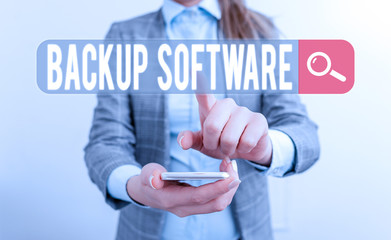 Writing note showing Backup Software. Business concept for create extra exact copies of files or...