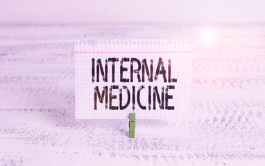 Writing note showing Internal Medicine. Business concept for dedicated to the diagnosis and medical treatment of adults Green clothespin white wood background reminder office supply