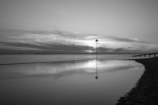 Black and white image of a sunset at Southend-on-Sea, Essex, England