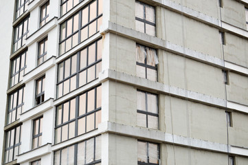 Windows and accessories of a new modern monolithic frame-block house under construction with windows, walls and balconies. Background, texture