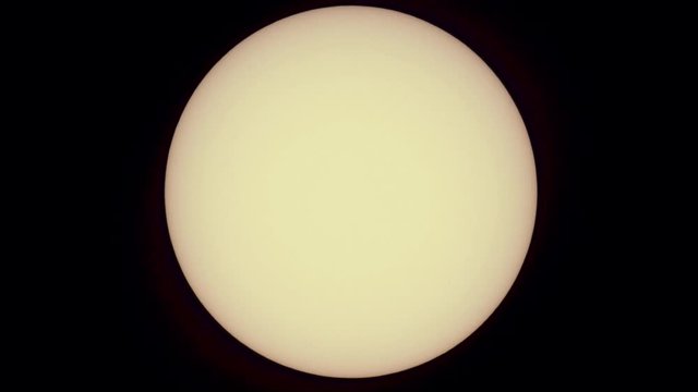 Telescopic view of the Sun as the International Space Station (ISS) transits in front of it in slow motion (1/4 speed).