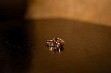 Pair of gold wedding rings on the table