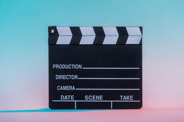 Movie clapper on neon background, cinema concept.