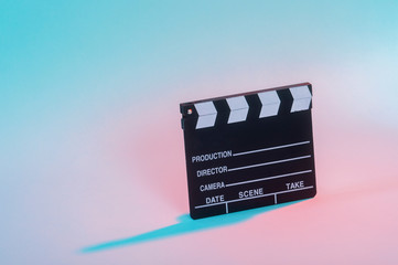 Movie clapper on neon background, cinema concept.