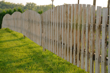 Low wood fence and lawn grass