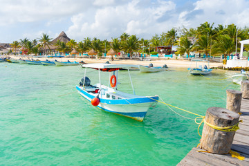 Puerto Morelos seaside view with sea and boats. Caribbean sky with clouds. White sand shore. Background or wallpaper. Yucatan. Quintana roo. Mexico. Riviera maya.