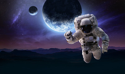 Obraz na płótnie Canvas Astronaut in the space over the nightly planet Earth. Abstract wallpaper. Spaceman. Elements of this image furnished by NASA