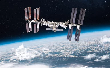 Fotobehang Internationaal ruimtestation in een baan om de planeet Aarde. ISS in de buitenste donkere ruimte. Elementen van deze afbeelding geleverd door NASA © dimazel