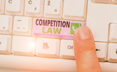 Conceptual hand writing showing Competition Law. Concept meaning regulating the monopoly and unfair...