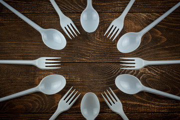 plastic forks and spoons lie in a circle