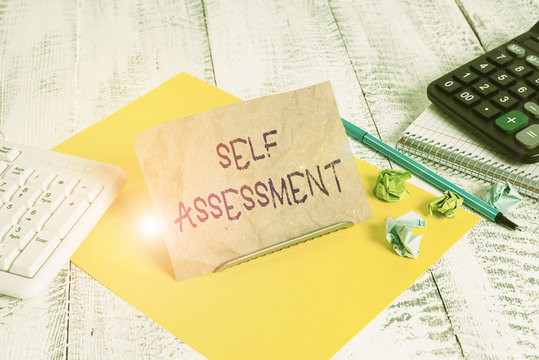 Writing note showing Self Assessment. Business concept for evaluation of oneself or one actions and attitudes Notepaper on wire in between computer keyboard and sheets