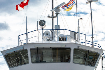 Close up of the command bridge of a passenger ferry. Canadian flag and technical navigation...
