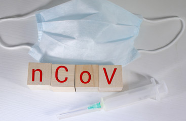 Novel coronavirus - 2019-nCoV, WUHAN virus concept. Surgical mask protective mask with CORONAVIRUS text. Chinese coronavirus outbreak. Red background.