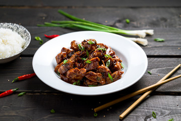 Delicious General Tso's Chicken dish angled view. General Tso's chicken (also tsao or tao) is a popular chinese restaurant food with deep-fried crispy chicken covered in a tasty sweet and spicy sauce.