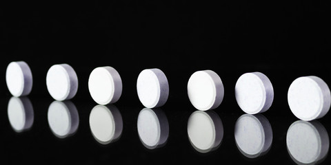 Tablets and pills on dark background