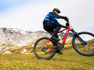Fototapeta premium Man riding a mountain bike in the snowy mountains