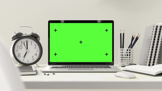 Laptop on table Work desk. Computer mock-up with green screen for your text with Notebook ,Mouse ,Alarm clock ,Paper Clip ,Pencil and Pin with white color. 3d render.