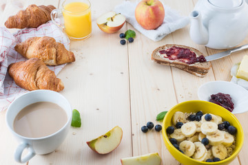 Good morning, great start to the day.  
Morning breakfast set with bowl of fruits of banana and berries.
