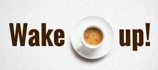 cup of coffee and text WAKE UP! on paper background